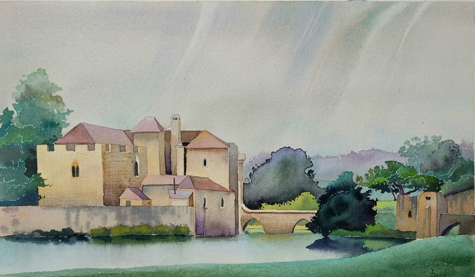A castle beside water beneath a soft gray sky