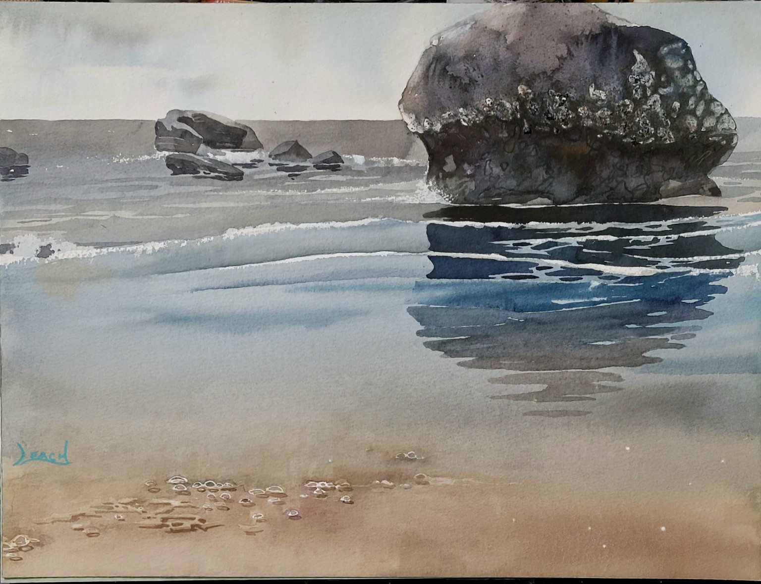 Gentle sea ripples around shoreline rocks